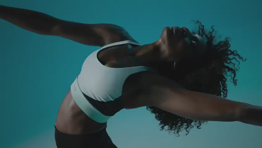 Athlete sprinting on a dimly lit track under a spotlight — symbolizing power, momentum, and the “Never Stop” mindset.